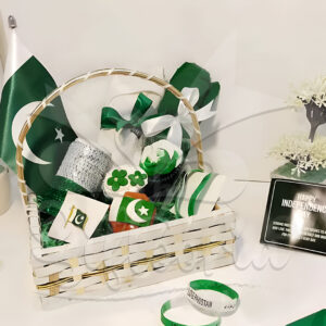 Azadi-e-Pak Hamper featuring a dupatta, polo shirt, wristband, table flag, cupcakes, bangles, badges, and net-wrapped basket – ideal for 14th August corporate gifting with company logo customization