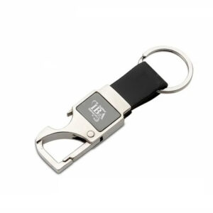 A silver metal keychain that includes a bottle opener and a clip, attached to a black leather strap and a metal key ring.